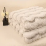 Folded soft white faux fur blankets