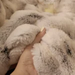 Hand holding soft faux fur blanket
