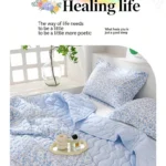 Cozy bed with light blue floral bedding