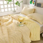 Sunlit bedroom with pale yellow bedding