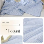 Light blue quilted bedding set on bed
