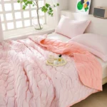 Soft pink quilted bed with pillows