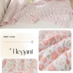Pink floral quilted bedding set on bed