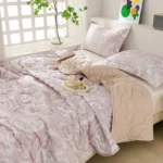 Soft pink paisley bedding on cozy bed
