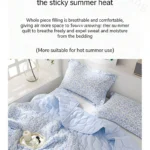 Light blue floral quilt and matching pillows