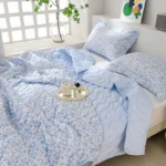 Light blue floral comforter and pillows
