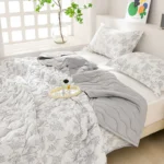 Cozy bed with gray botanical patterned bedding