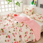 Pink floral comforter and pillows on bed