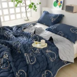 Navy blue comforter, pillows, tray by window