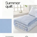 Light blue floral summer quilt folded on bed